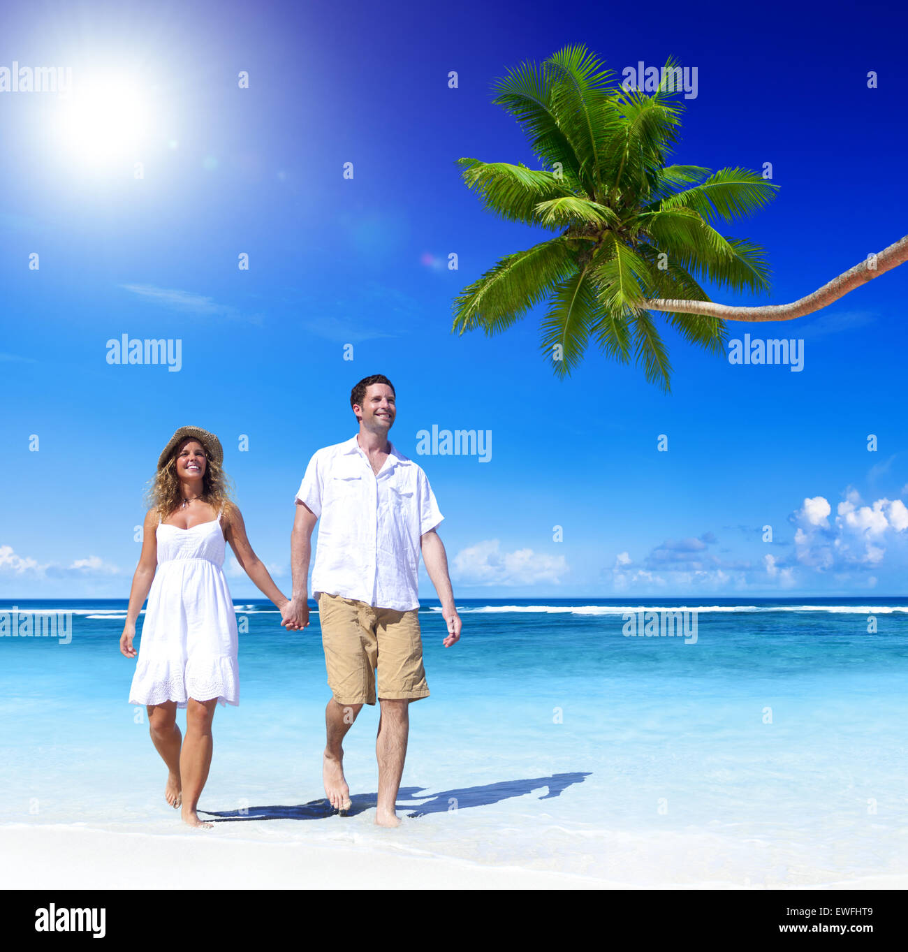Couple relaxing on the beach Stock Photo - Alamy