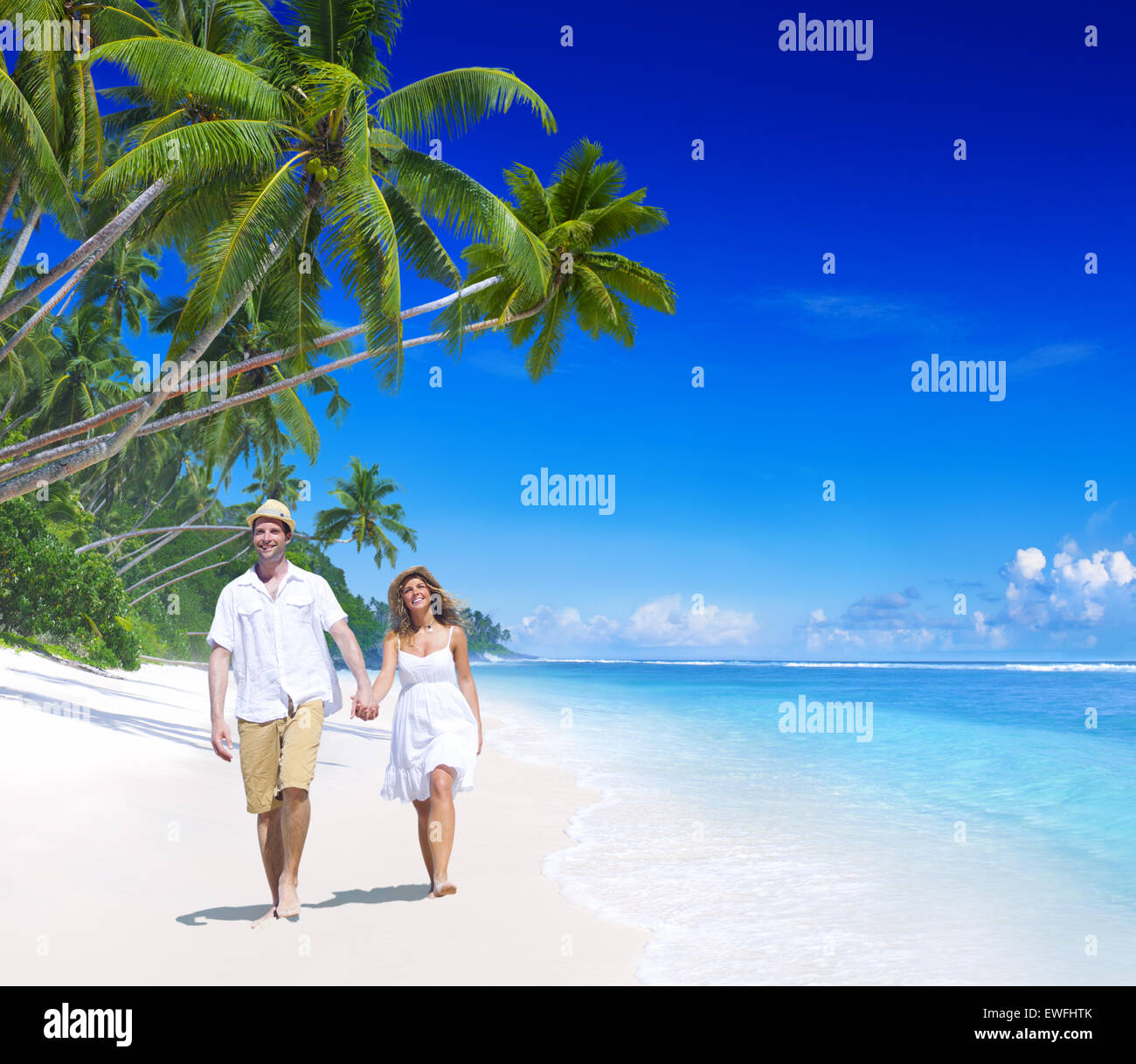 Couple relaxing on the beach Stock Photo - Alamy