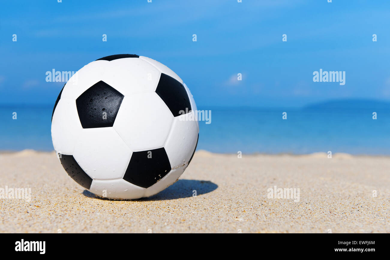 Football on the beach Stock Photo - Alamy