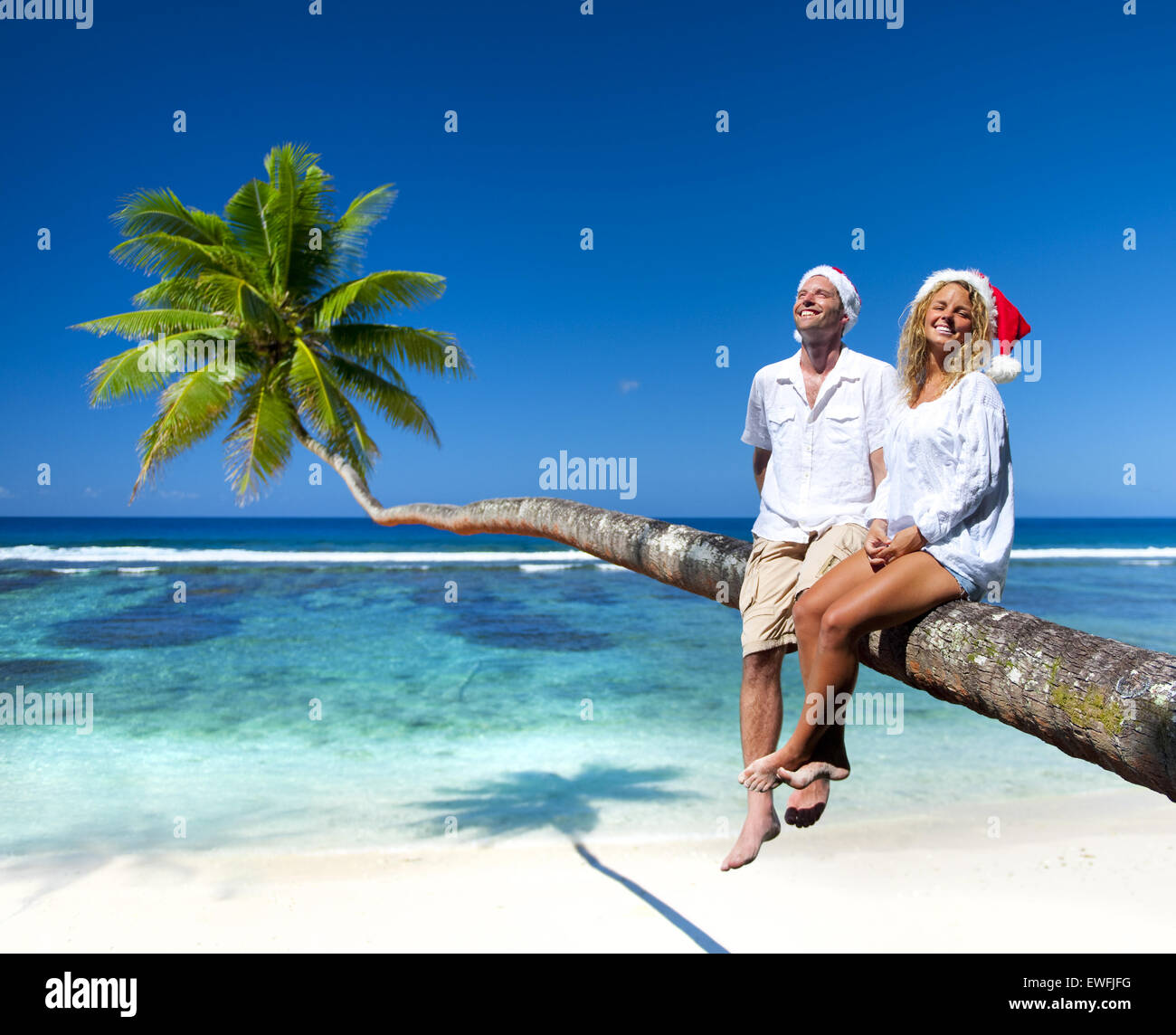 Couple relaxing on the beach Stock Photo - Alamy