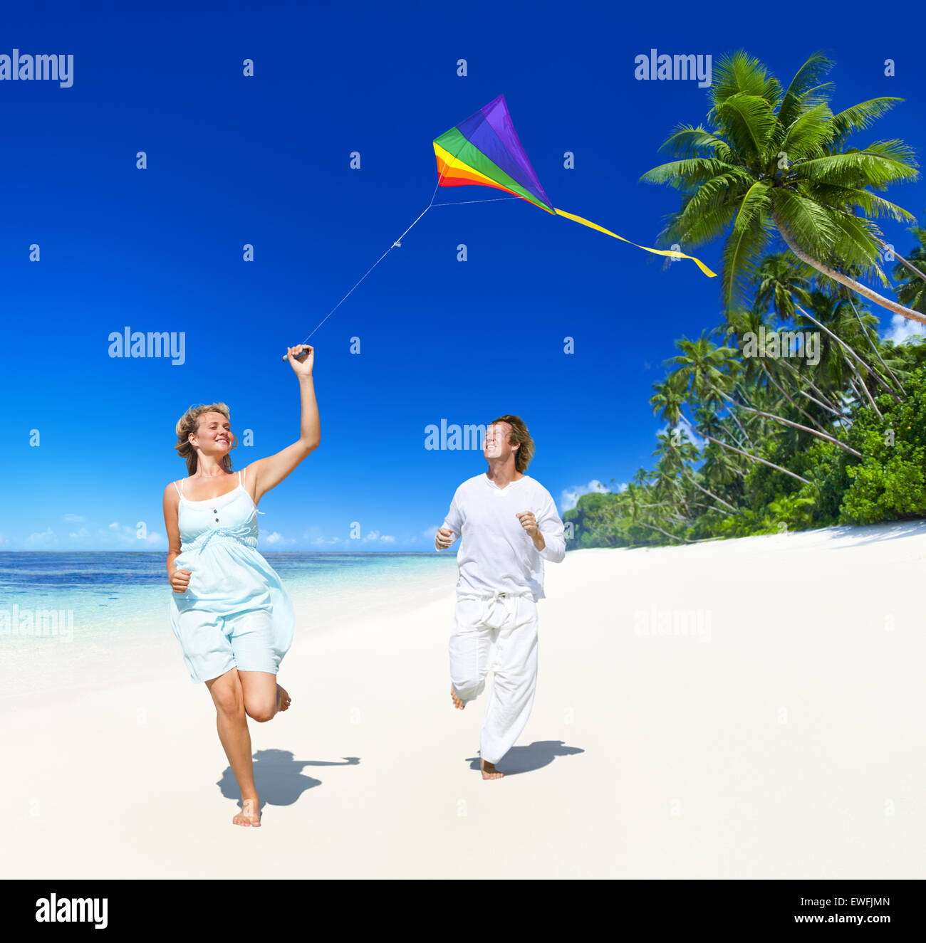 A couple flying a kite on the beach Stock Photo Alamy
