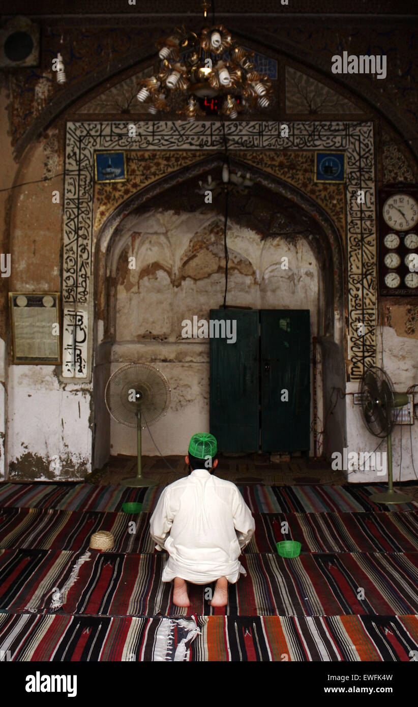 Lahore. 25th June, 2015. A Pakistani Muslim offers evening prayers during the fasting month of Ramadan at a mosque in eastern Pakistan's Lahore, June 25, 2015. Credit:  Jamil Ahmed/Xinhua/Alamy Live News Stock Photo