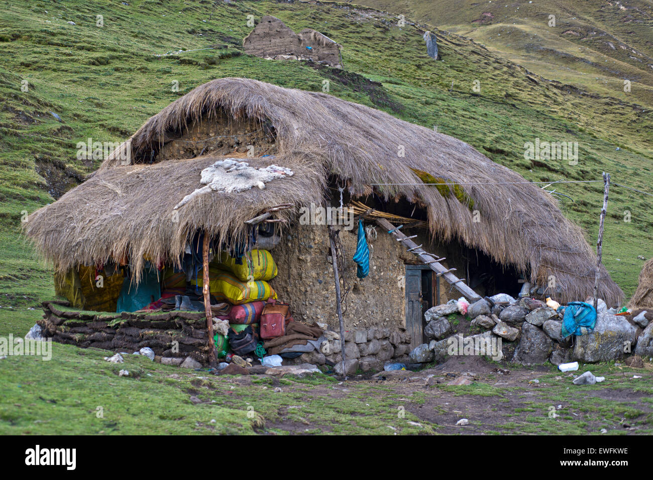 Typical, traditional dwelling house, built of mud and stones, thatched with grass, Cordillera Huayhuash mountain range, Andes Stock Photo