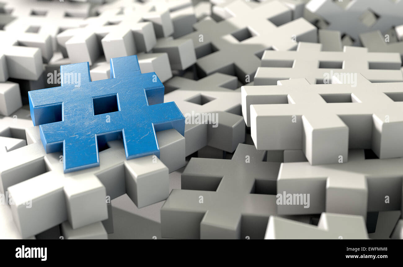 A concept image showing a scattered collection of white hashtags and a single blue one on an isolated studio background Stock Photo