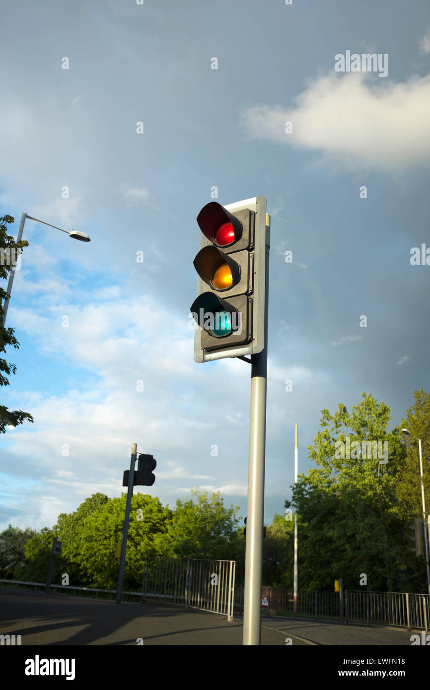 Street Light Traffic Light Signal against Stormy Dark Sky Stock Photo