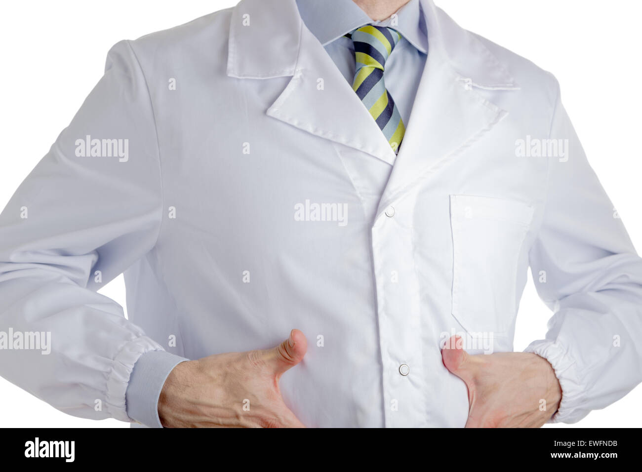 Man dressed with medical white coat, light blue shirt and glossy regimental tie with dark blue, light blue and green stripes, is pointing to his belly with both hands, driving attention to his stomach Stock Photo