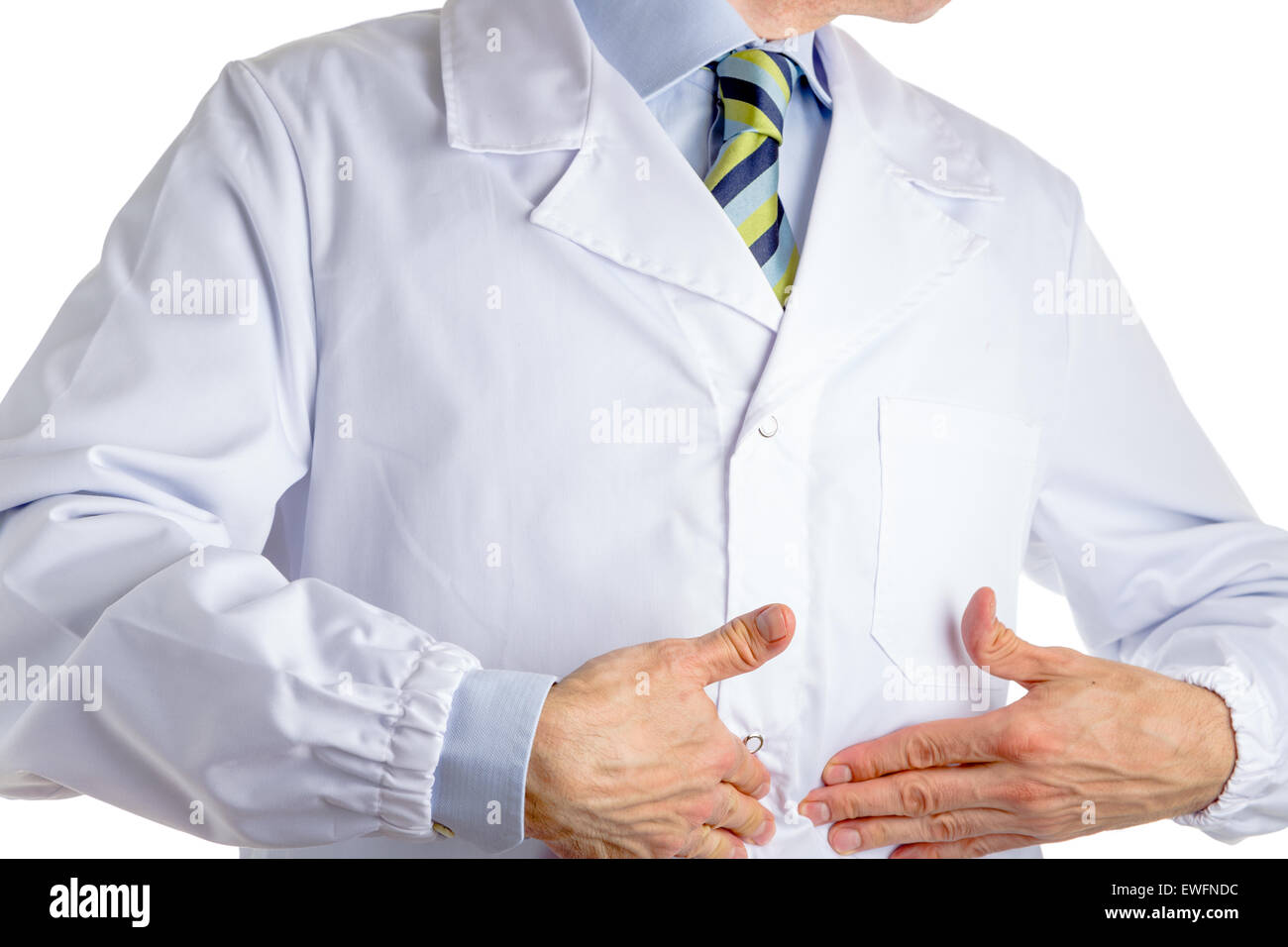 Man dressed with medical white coat, light blue shirt and glossy regimental tie with dark blue, light blue and green stripes, is pointing to his belly with both hands, driving attention to his stomach Stock Photo