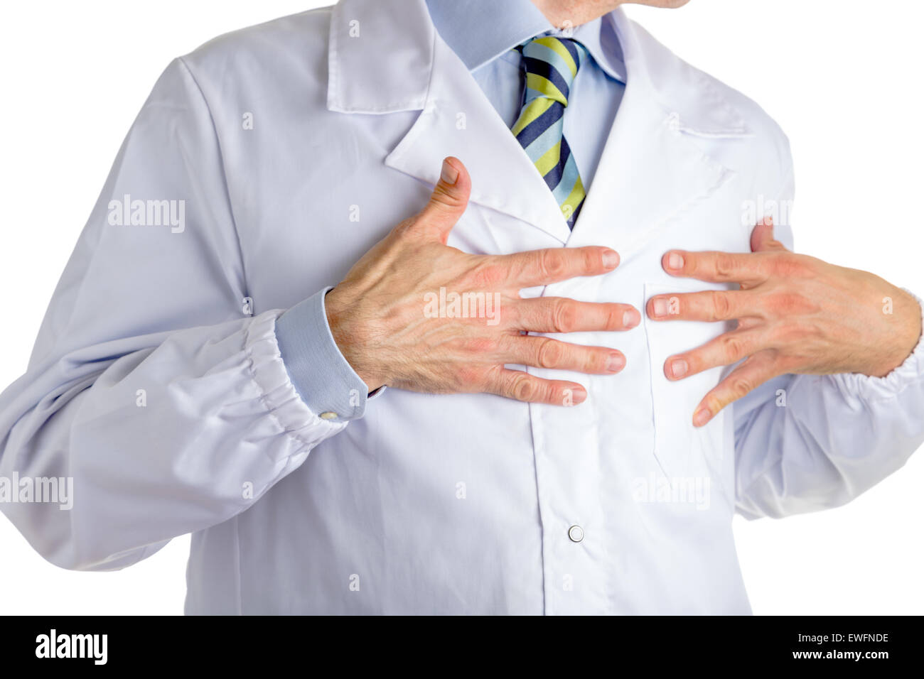 Man dressed with medical white coat, light blue shirt and glossy regimental tie with dark blue, light blue and green stripes, is pointing to his chest with both hands, driving attention to his heart Stock Photo
