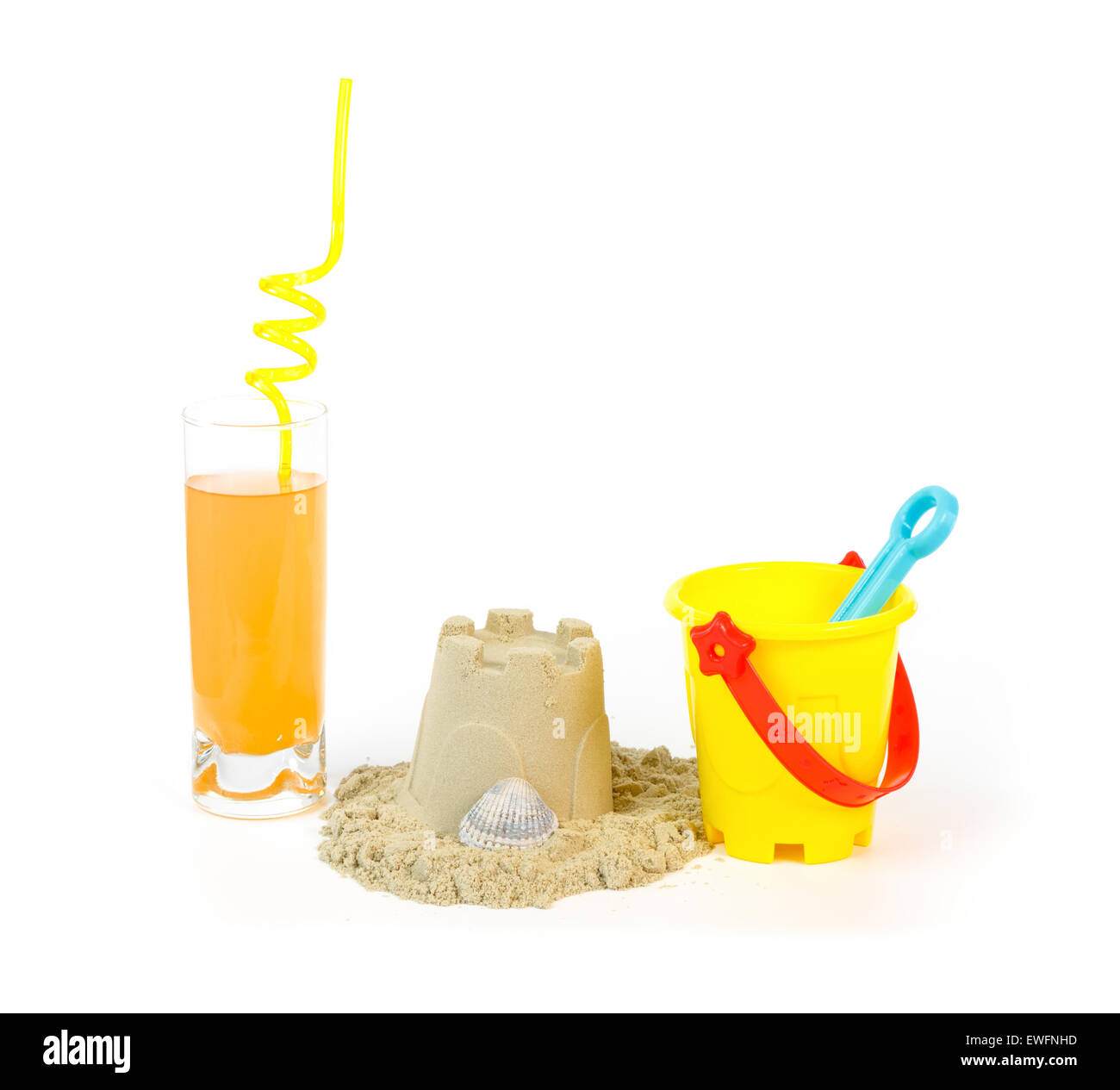 Yellow toy bucket, sandcastle with shell and a refreshing drink against white background Stock Photo