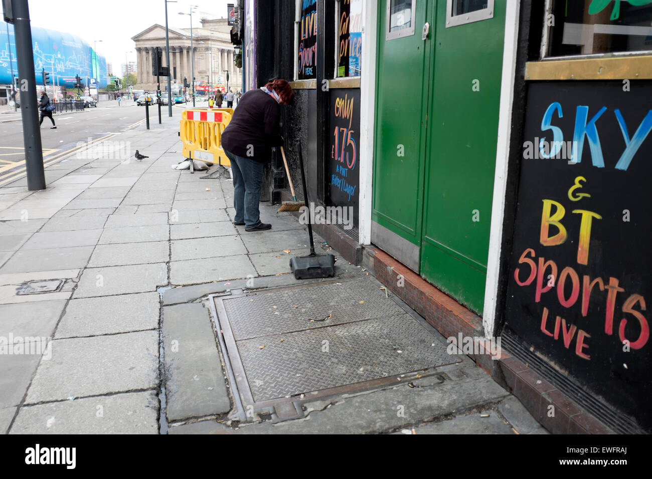 Sweeping Brushing Cigarette Ends Outside Pub Stock Photo