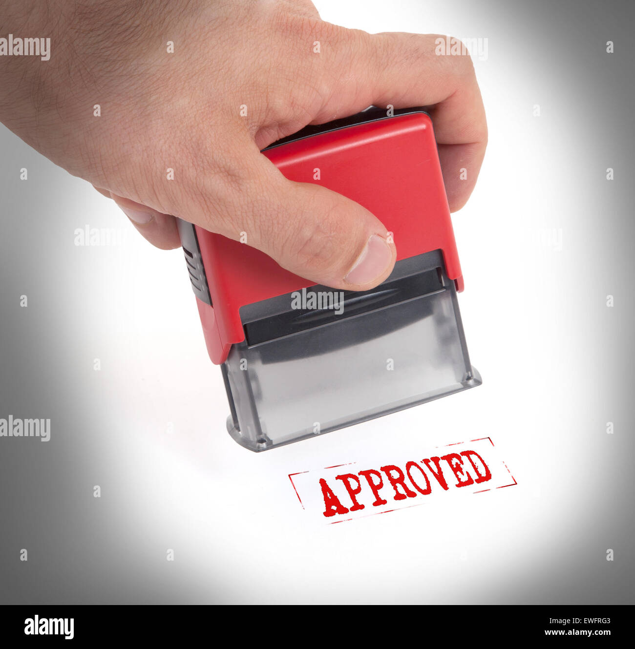 Plastic stamp in hand, isolated on white Approved Stock Photo Alamy