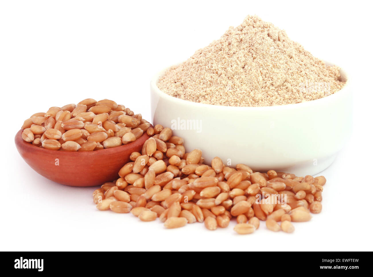 Wheat and reddish flour over white background Stock Photo