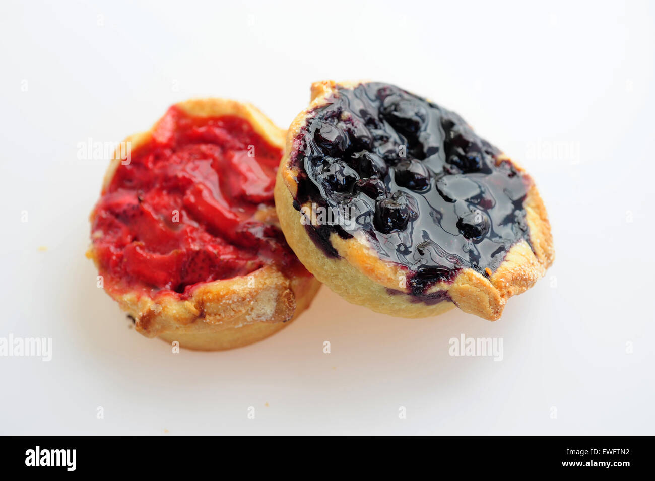 Food sweets desserts baked goods a rhubarb and strawberry tart and a blueberry tart Stock Photo