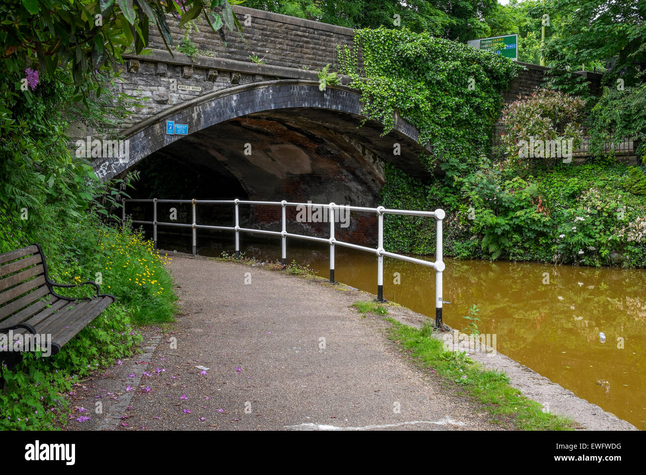 Bridgewater Canal going under a bridge with tow path  and railings Stock Photo