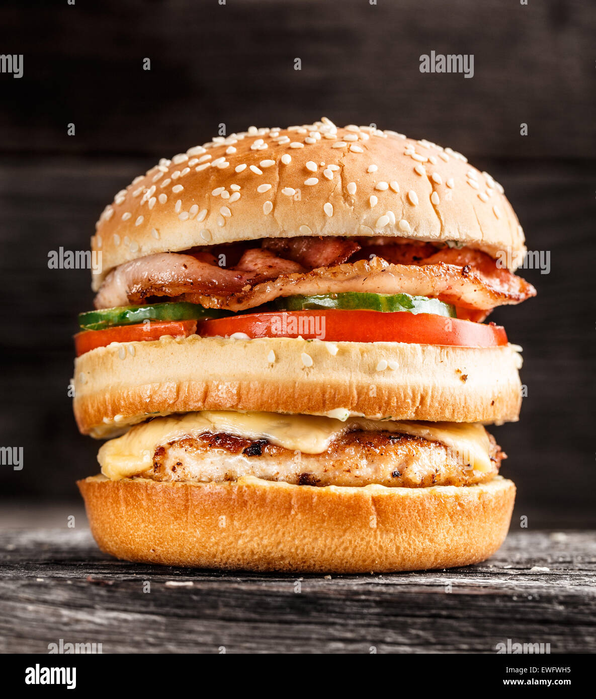 Double burger with chicken, bacon and vegetables Stock Photo - Alamy