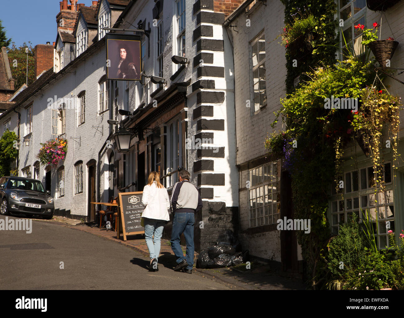 UK, England, Shropshire, Bridgnorth, couple walking up Cartway past Black Boy Inn Stock Photo