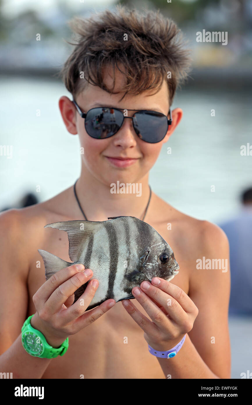 Pass a Grille Beach, USA, Boy proudly displays his fished fish Stock Photo