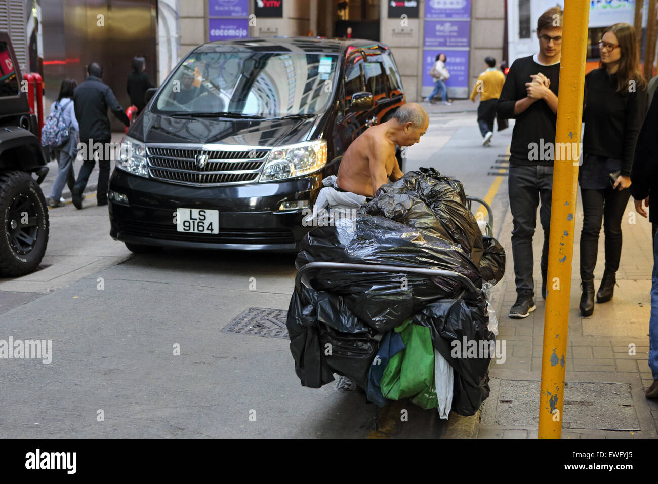 Hong Kong, China, man collects garbage on a street a Stock Photo