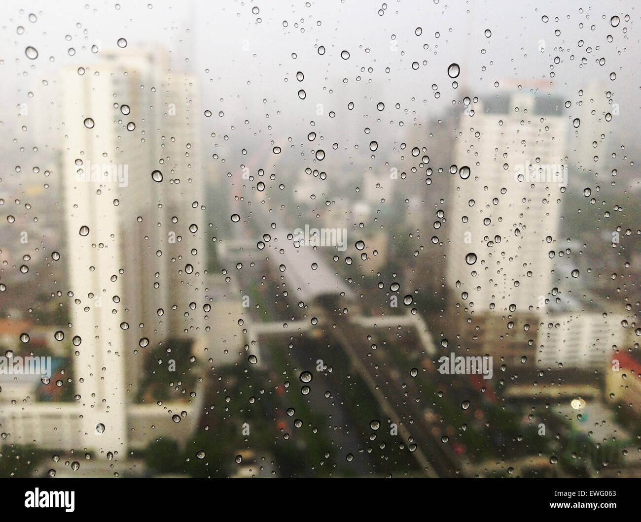 Water Droplets on Window Showing City Skyscrapers Stock Photo