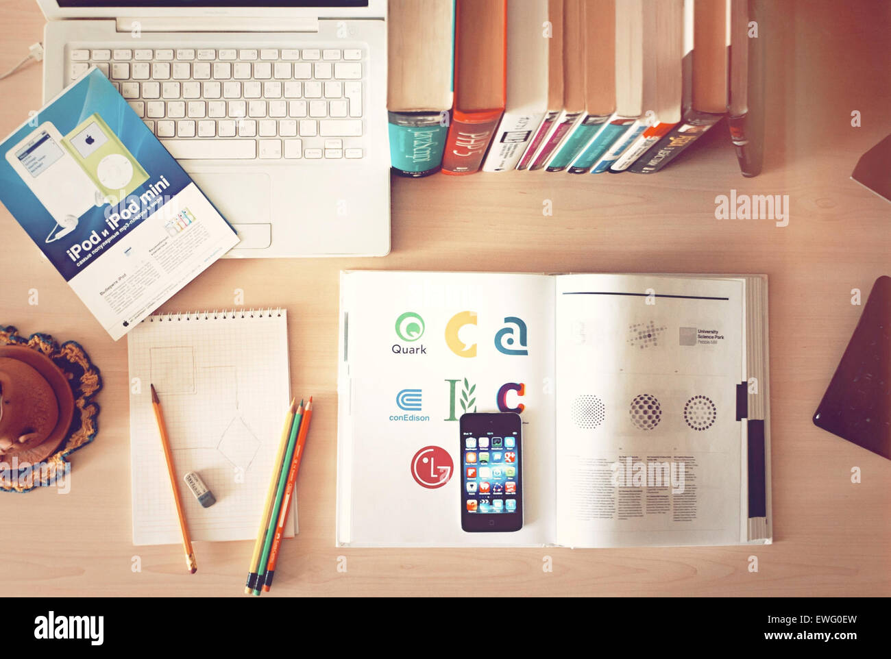 This image showcases a desktop still life with a combination of books ...