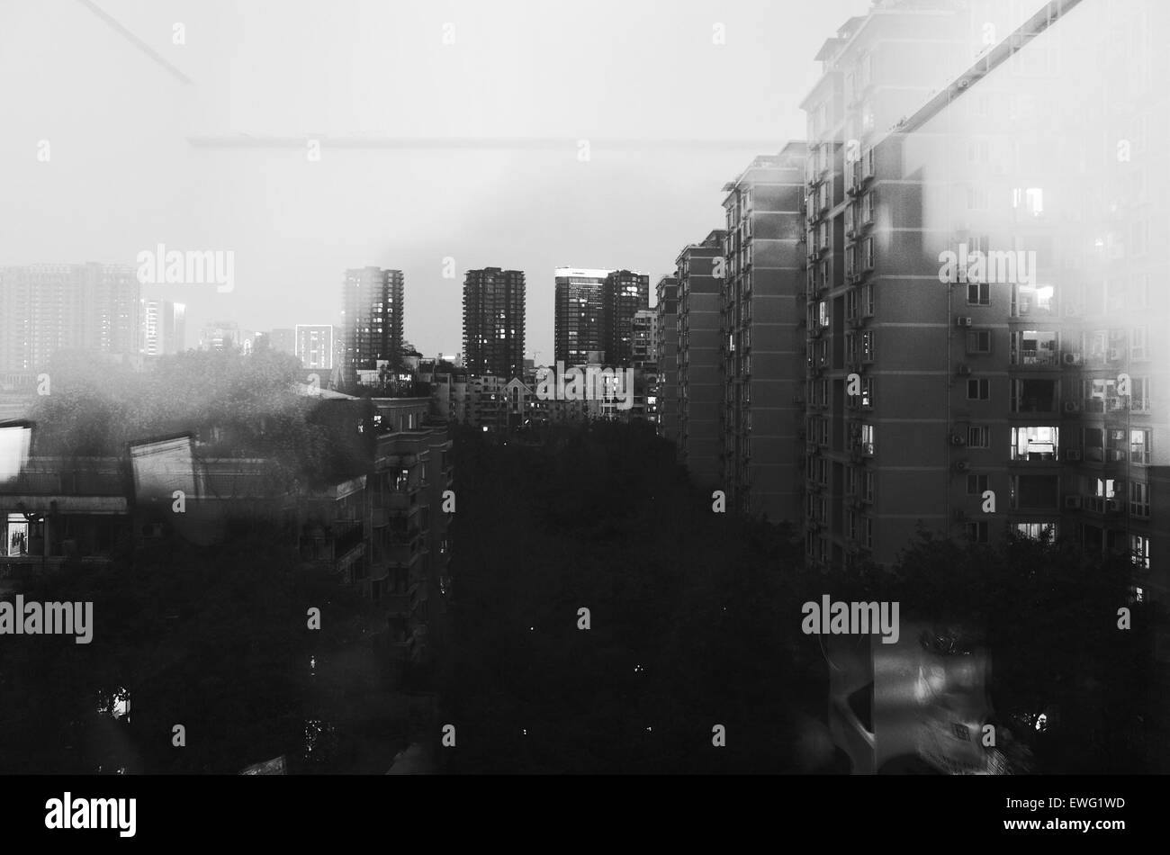 A black and white photograph of towering skyscrapers against a city ...