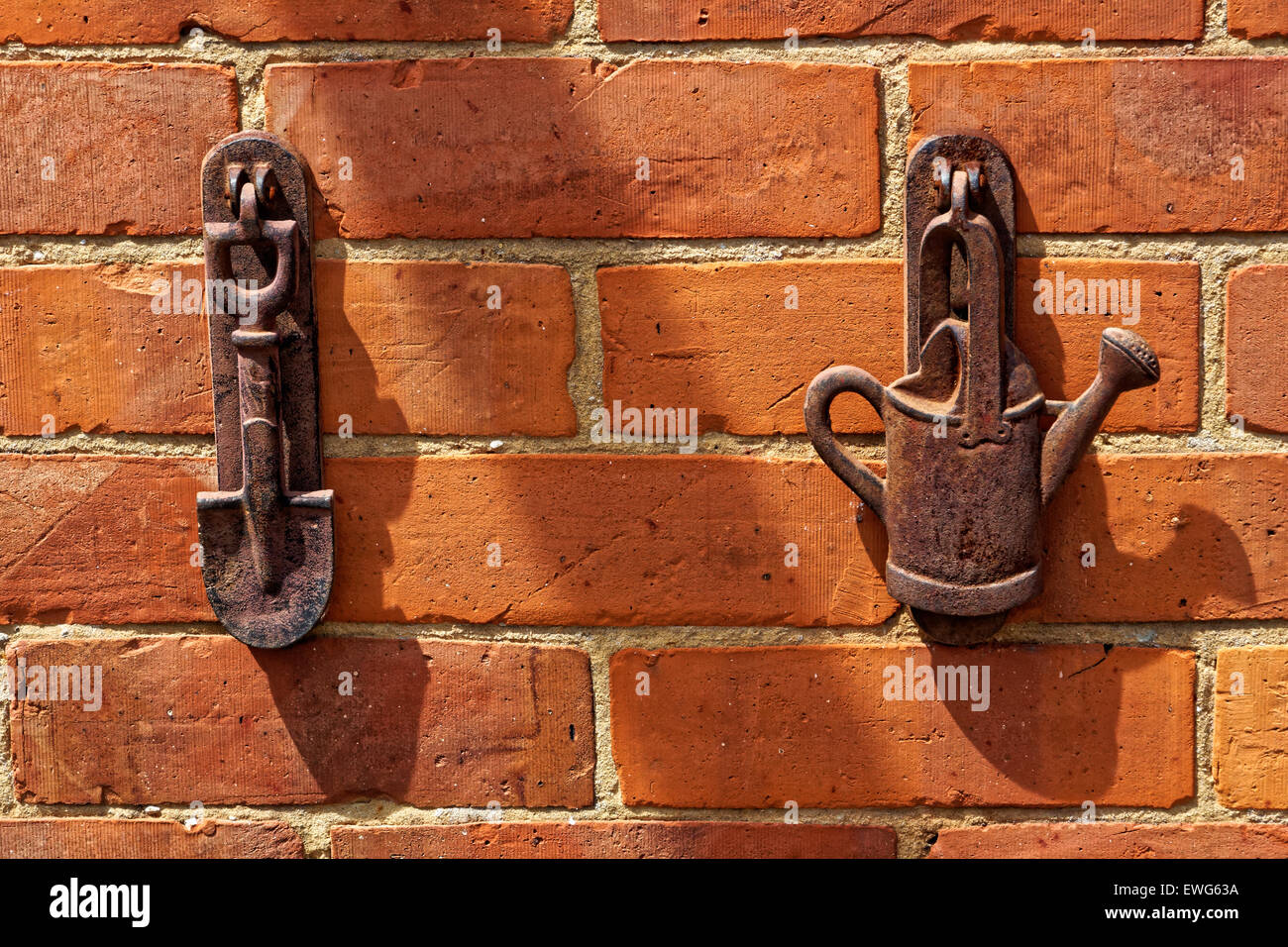 Iron garden ornaments on brick wall Stock Photo