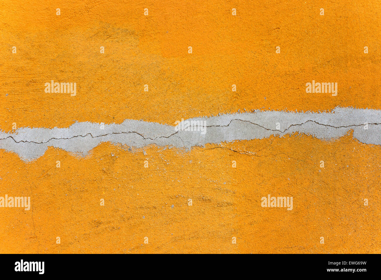 Orange mortar wall texture with gray crack as  background Stock Photo