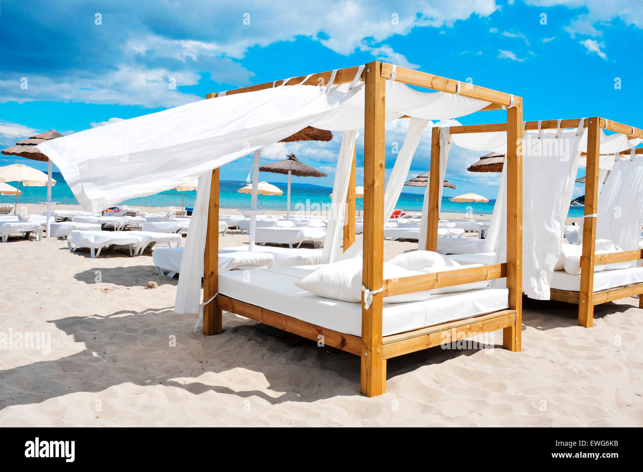 detail of some beds and sunloungers in a beach club in a white sand beach in Ibiza, Spain Stock Photo