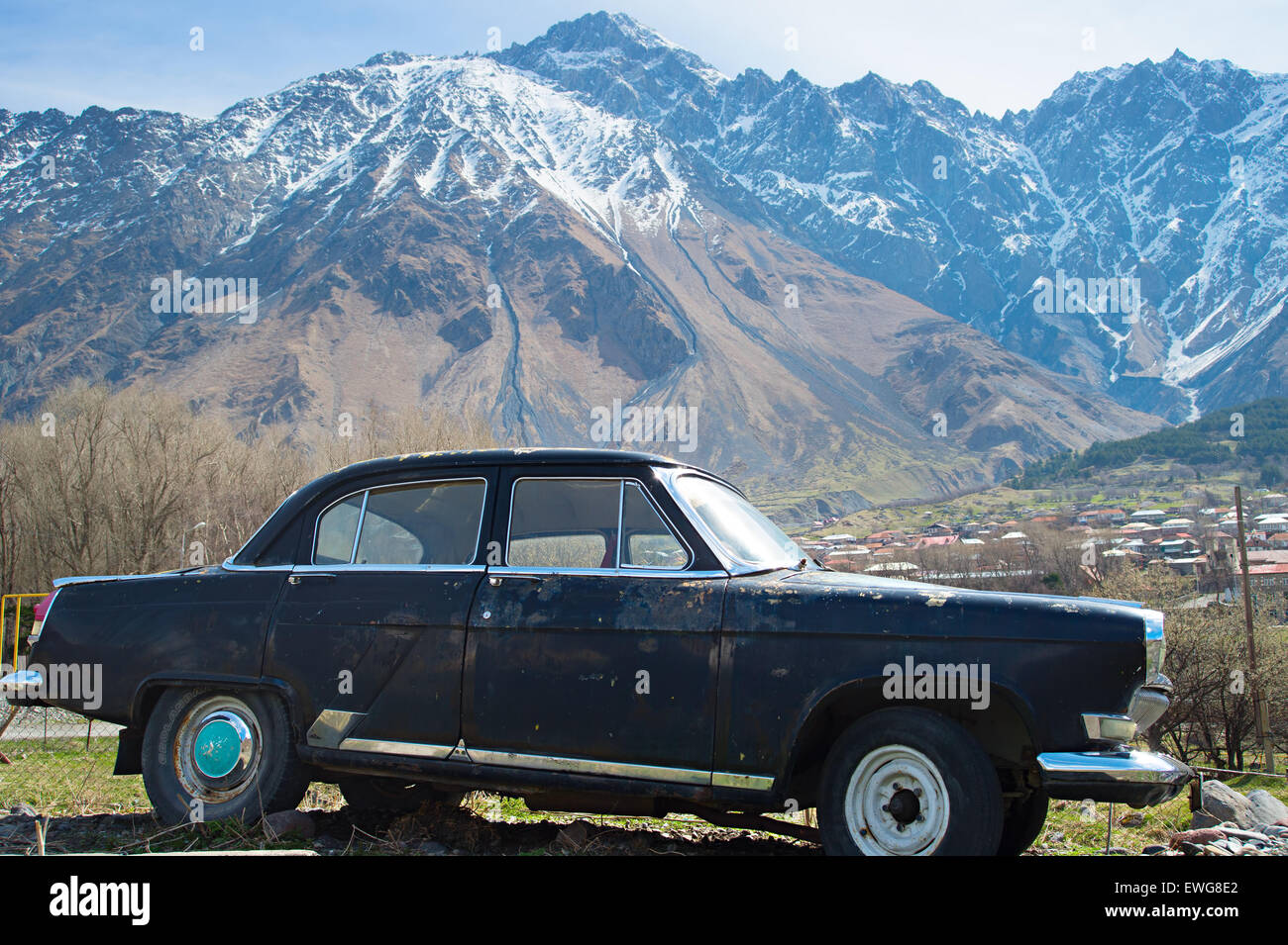 Retro soviet car and mountains on the background. Georgia Stock Photo