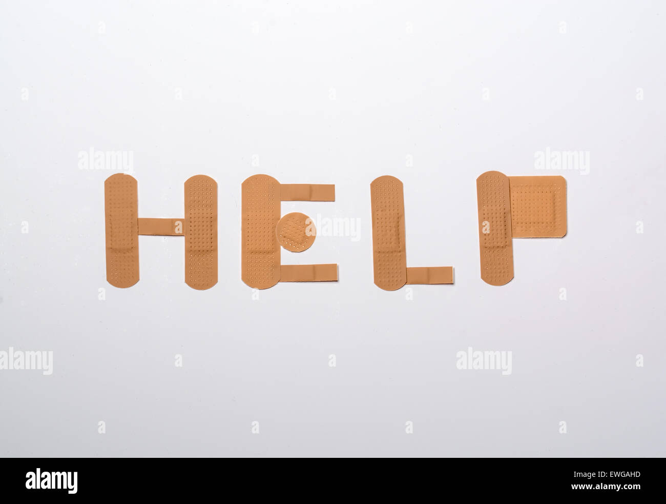 bandages forming the word help over white background Stock Photo Alamy