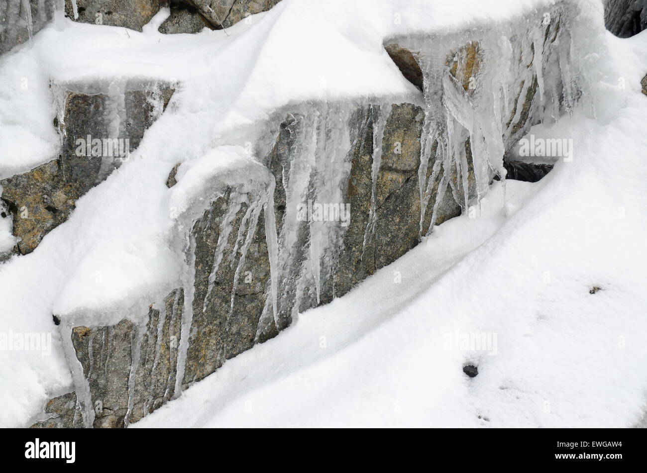 Snow and ice covering granite rocks Stock Photo - Alamy