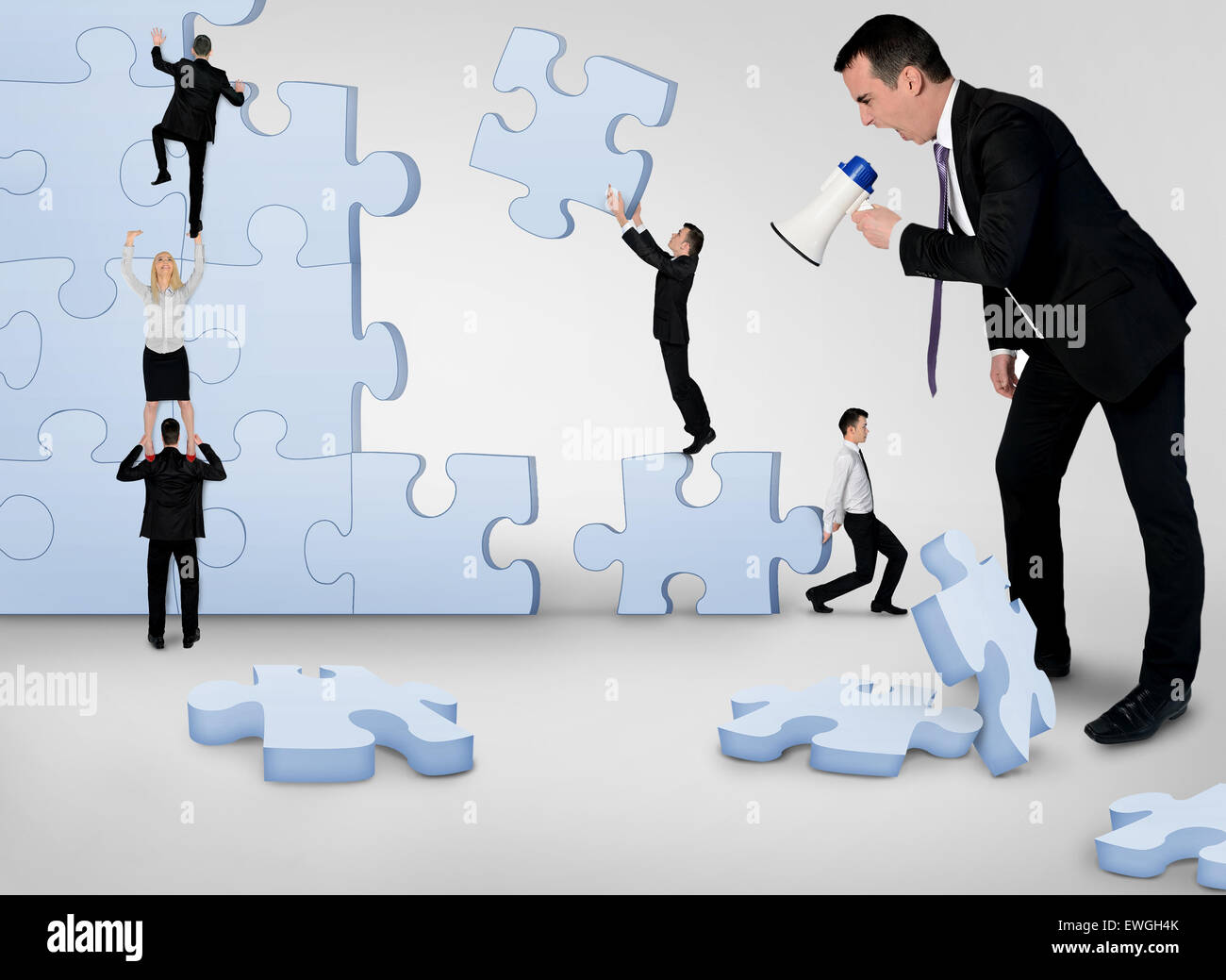 Business team building puzzle pieces together Stock Photo