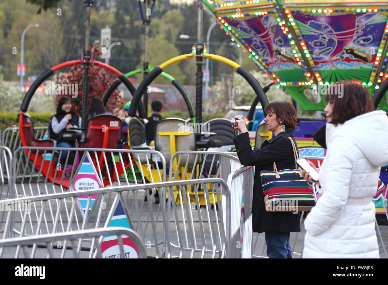Coquitlam, BC, Canada - April 09, 2015 : People having fun at the West Coast Amusements Carnival Stock Photo