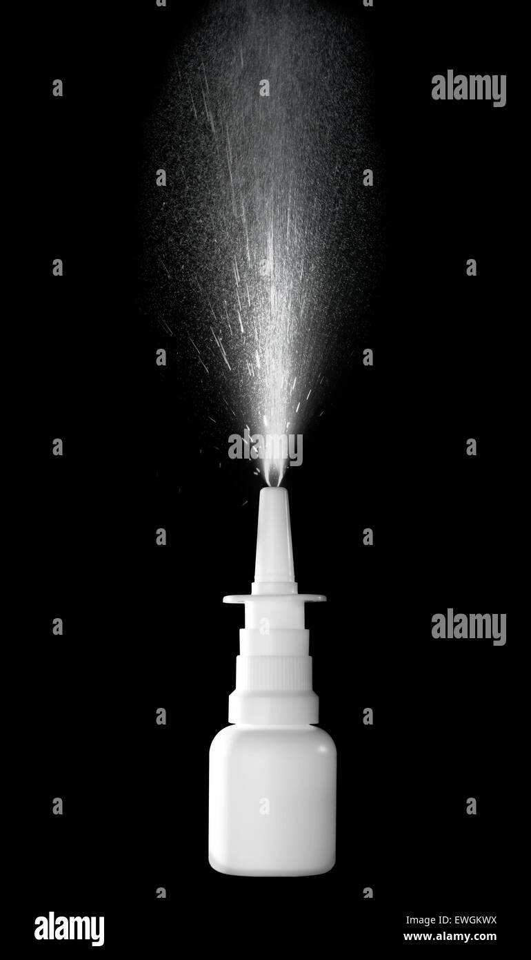 Stock image of nasal spray bottle while spraying over black background Stock Photo