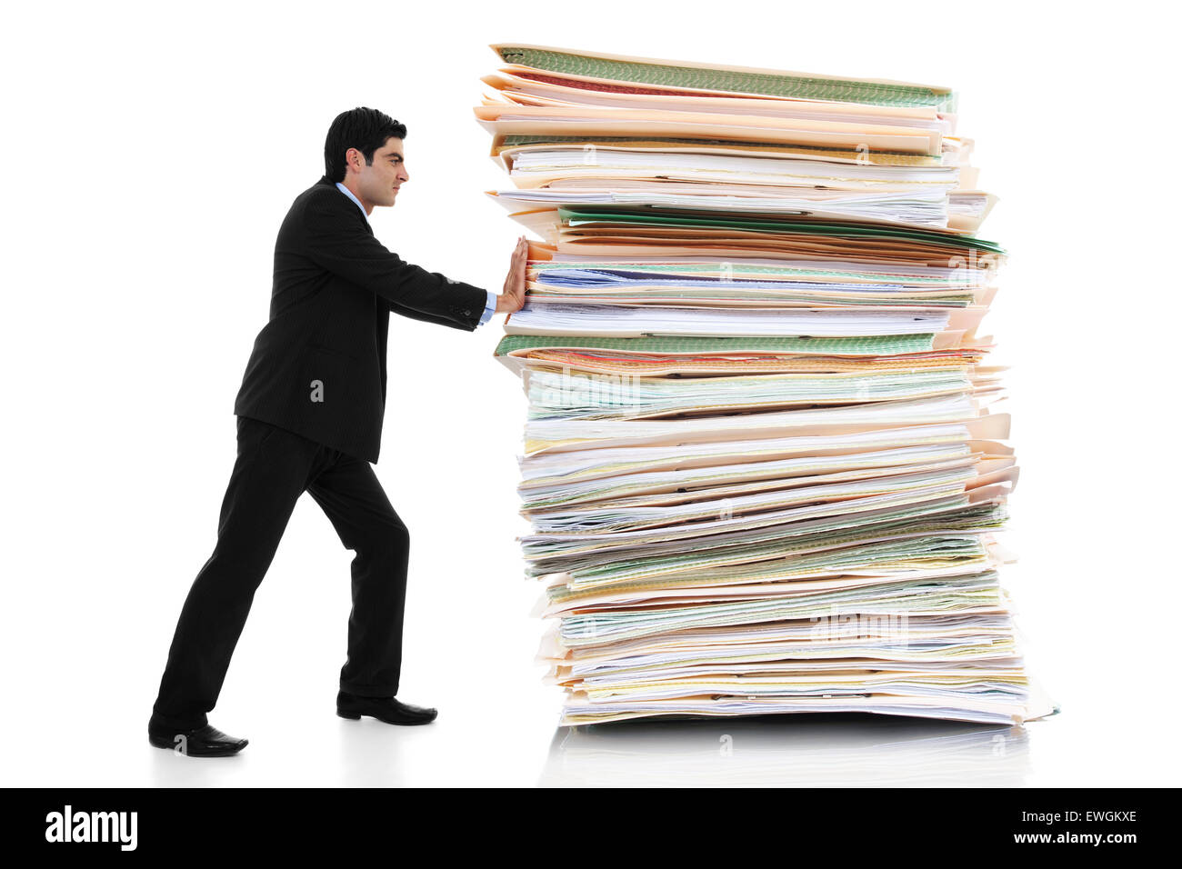 Stock image of businessman pushing a giant stack of documents isolated on white background Stock Photo