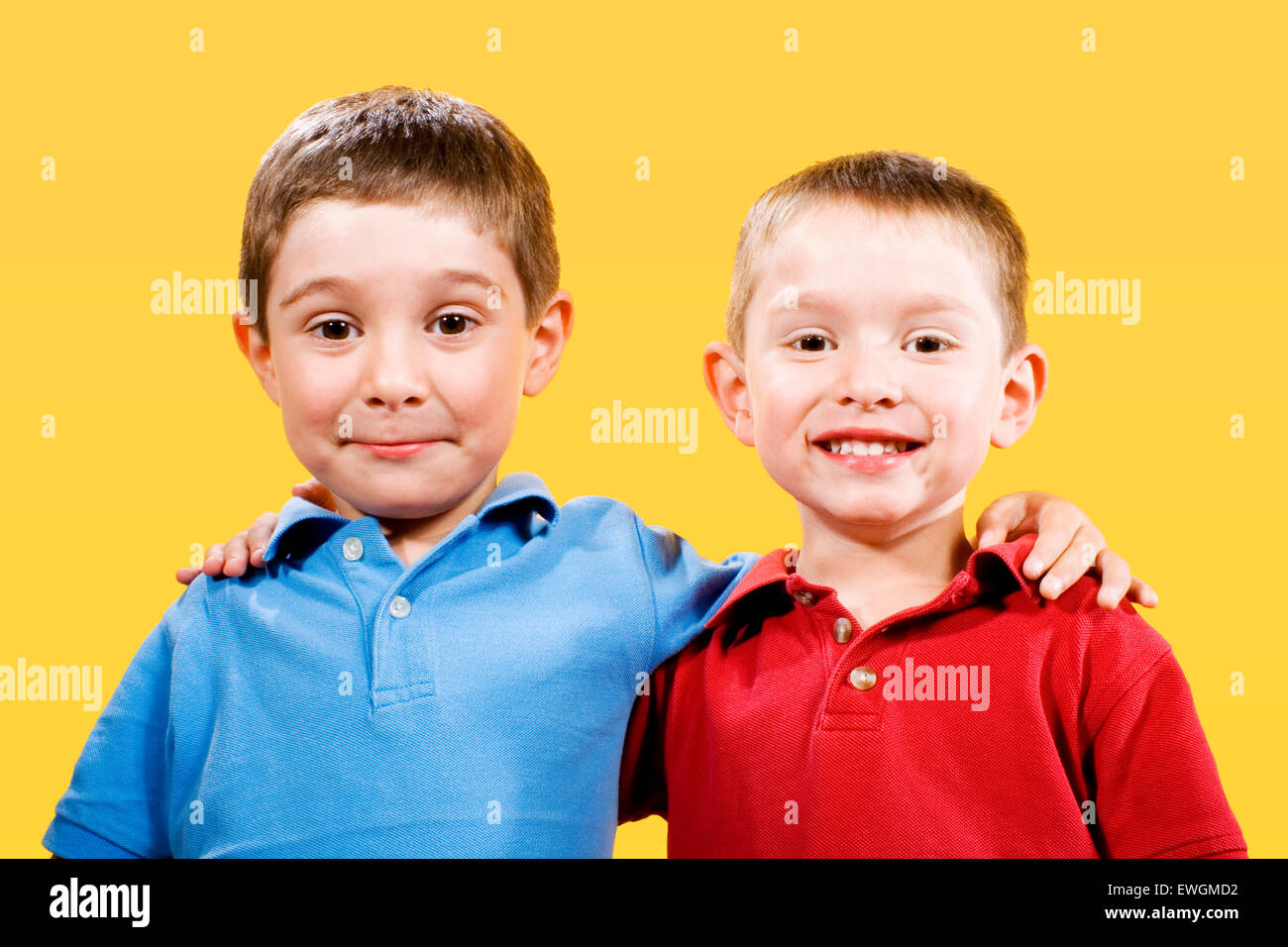 Stock photo of two children over yellow background Stock Photo