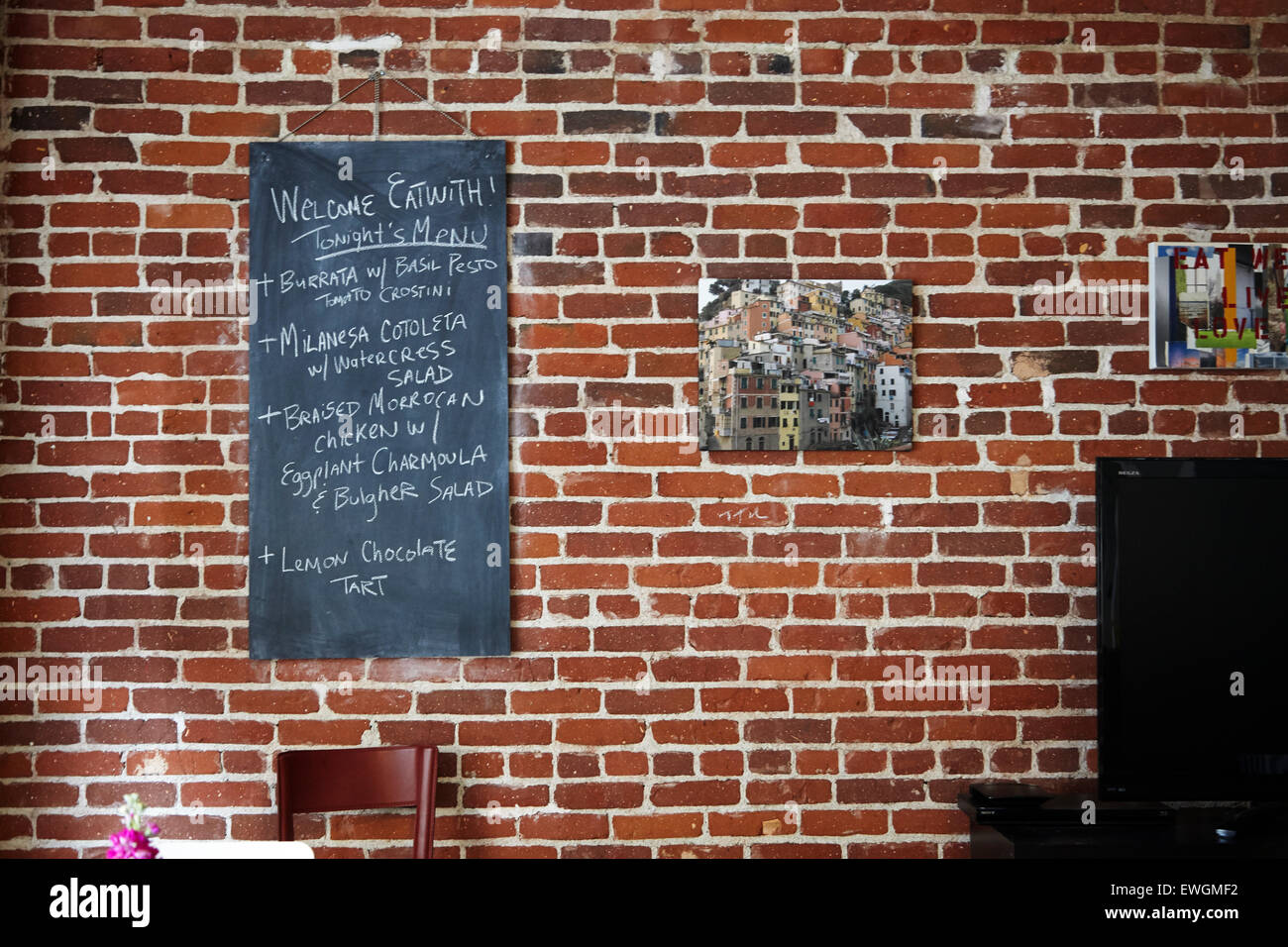 Red brick wall with chalk board menu Stock Photo Alamy