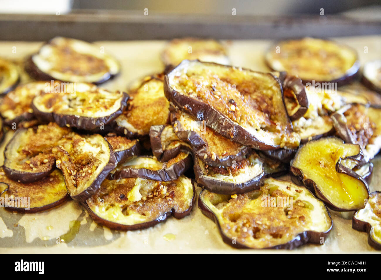 grilled eggplants on a cookie sheet on a grease paper bread crumbs on