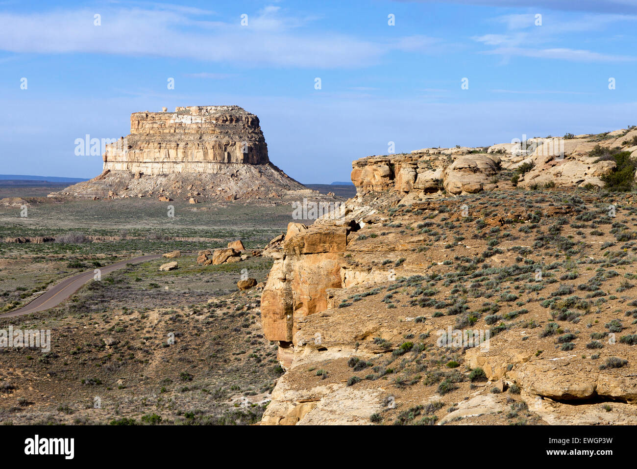 The 380 foot tall Fajada Butte rises above the valley floor in Chaco Culture National Historic Park. The ruins of about two doze Stock Photo