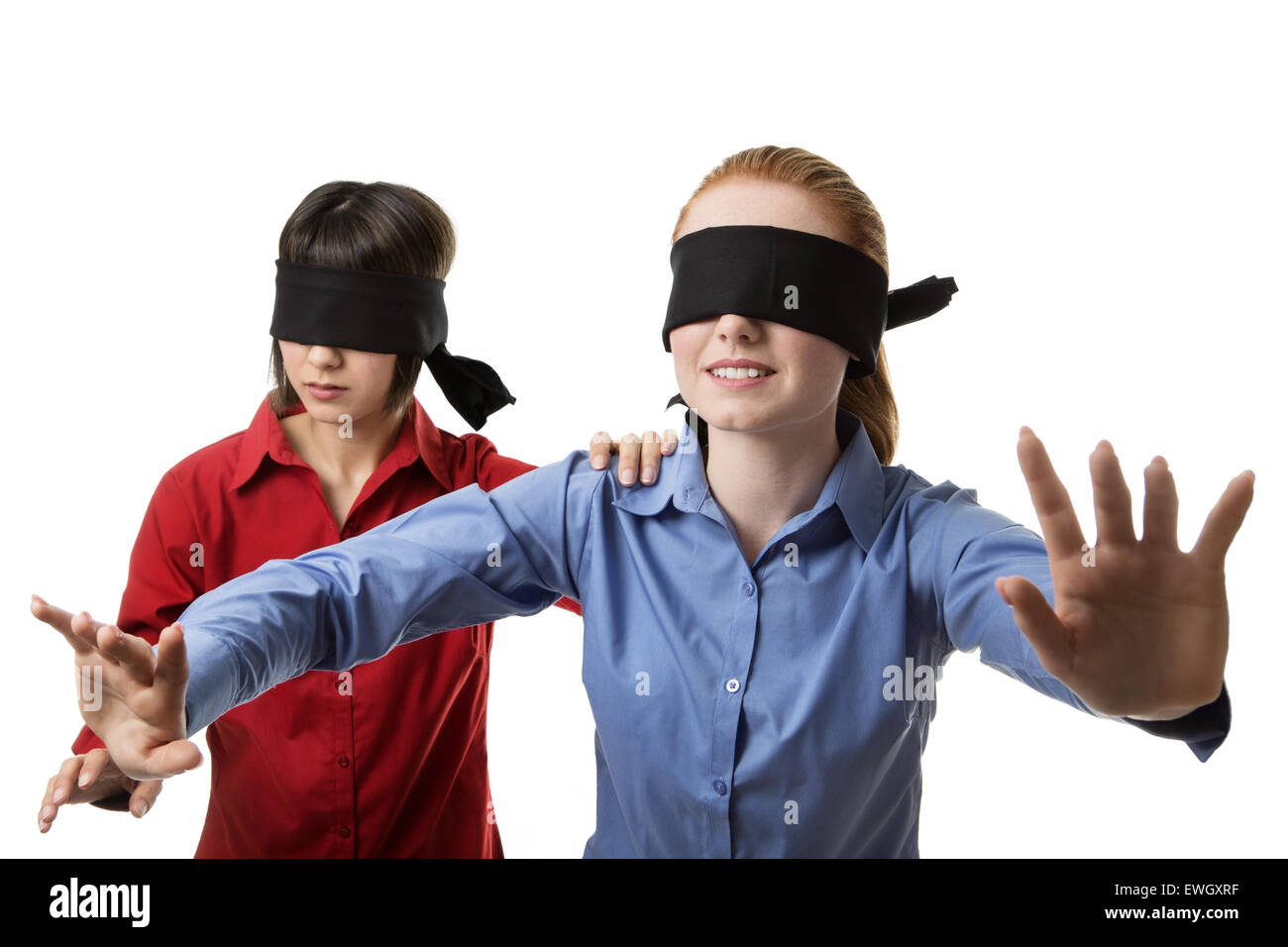 two business woman blind folded leading the other Stock Photo