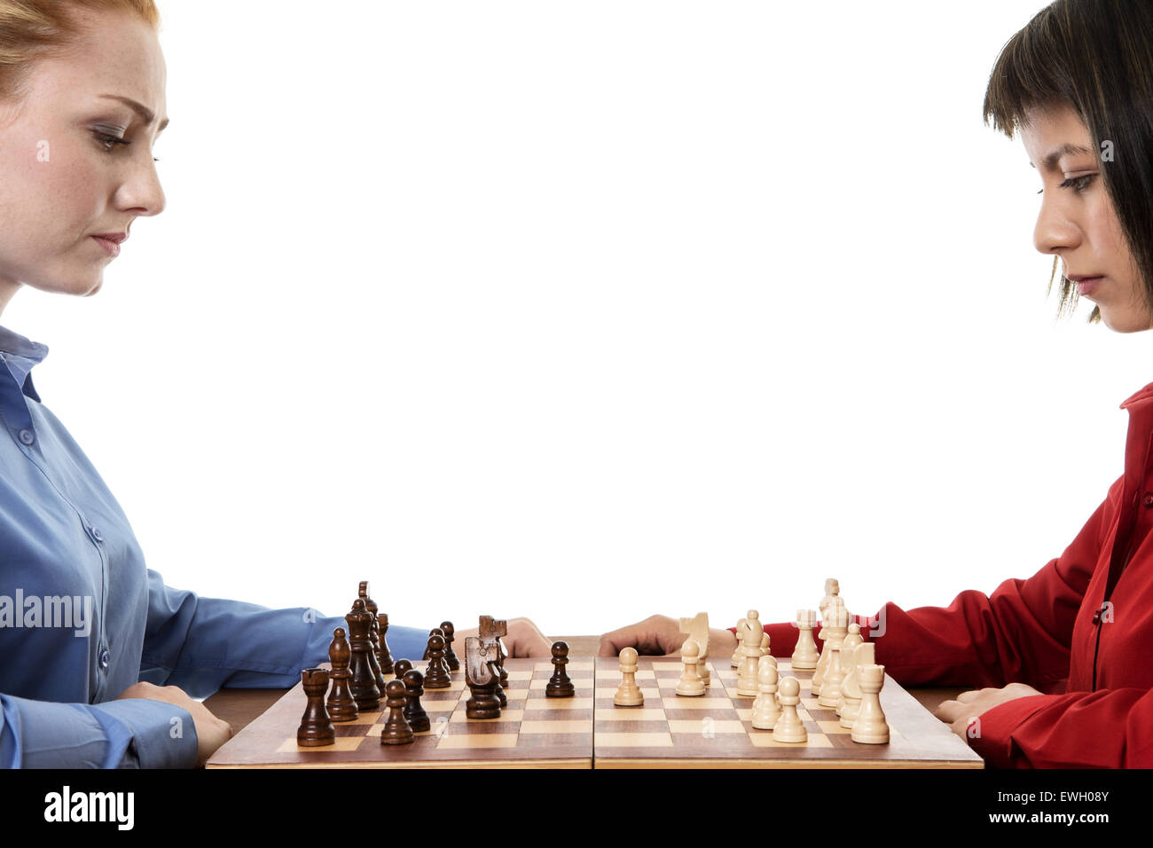 two business woman playing chess together trying to out think each other Stock Photo