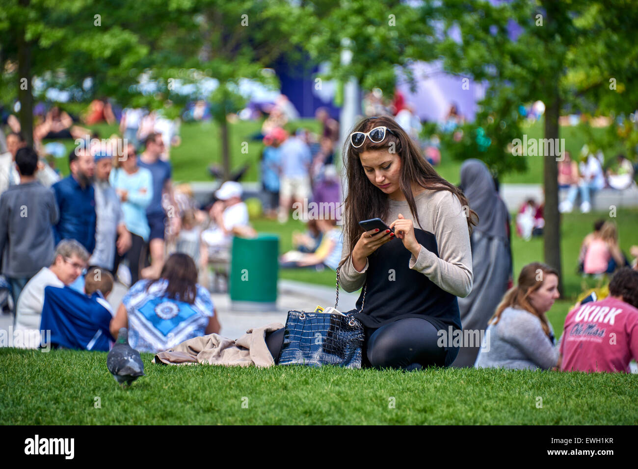 Lady reading in the Jubilee Gardens public park on the South Bank in the London Borough of Lambeth. Stock Photo