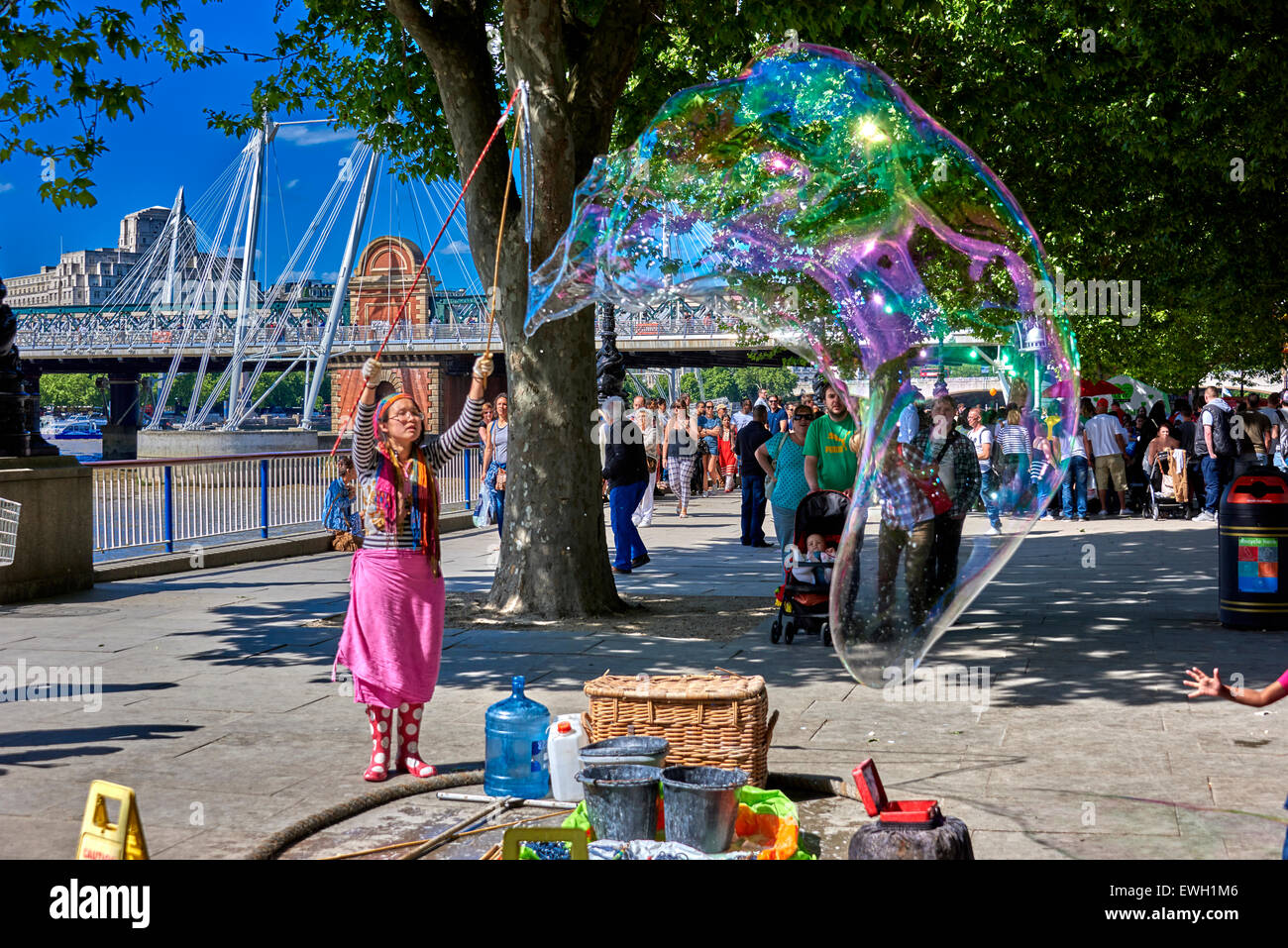 Street performers in Jubilee Gardens Public Park on the South Bank in the London Borough of Lambeth. Stock Photo