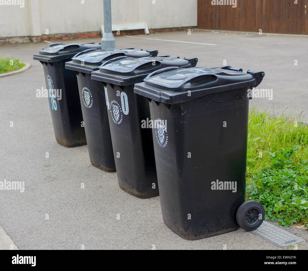 Four wheelie bins on the road side waiting to be emptied Stock Photo