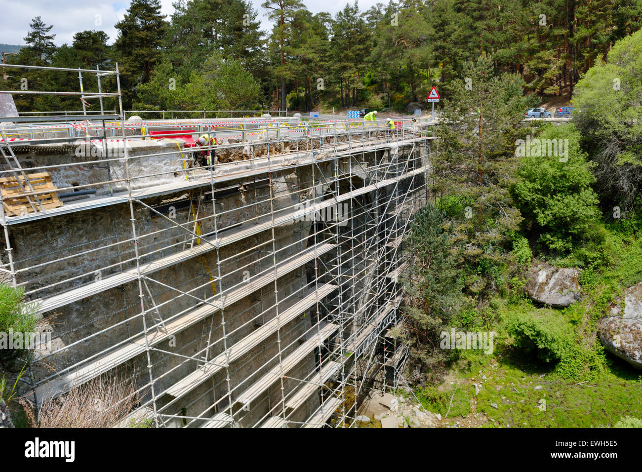 Refurbishment work on historic stone road bridge over the river Eresma on CL601 road, Spain Stock Photo