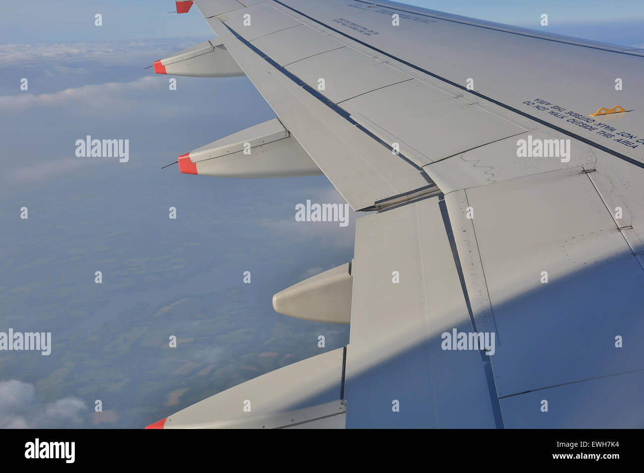 The wing of an aeroplane with ailerons Stock Photo