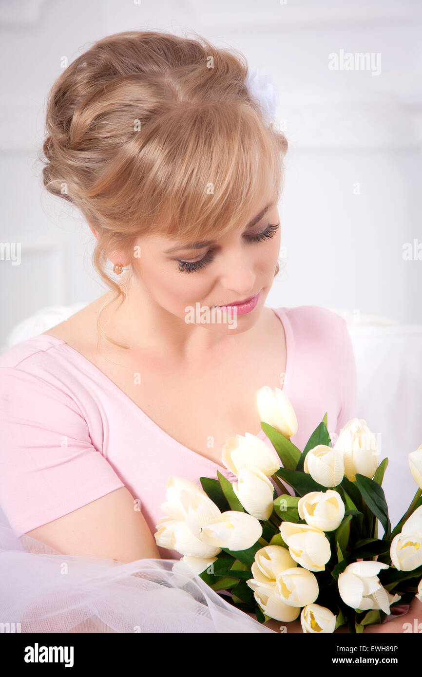 Beautiful blonde woman with a bouquet of tulips Stock Photo - Alamy