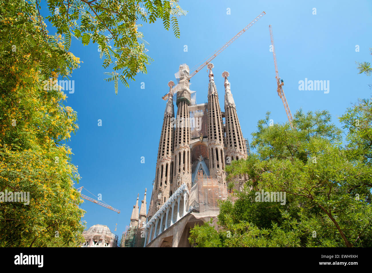 SAGRADA FAMILIA Exterior view of the famous church with cranes and scaffolding designed by Antonio Gaudi. Barcelona Spain Stock Photo