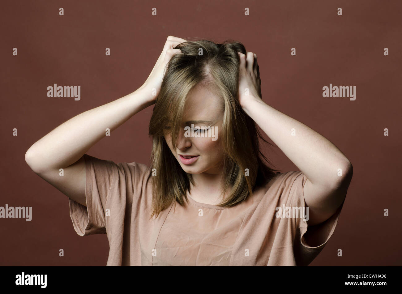 Young woman scratching itchy scalp Stock Photo