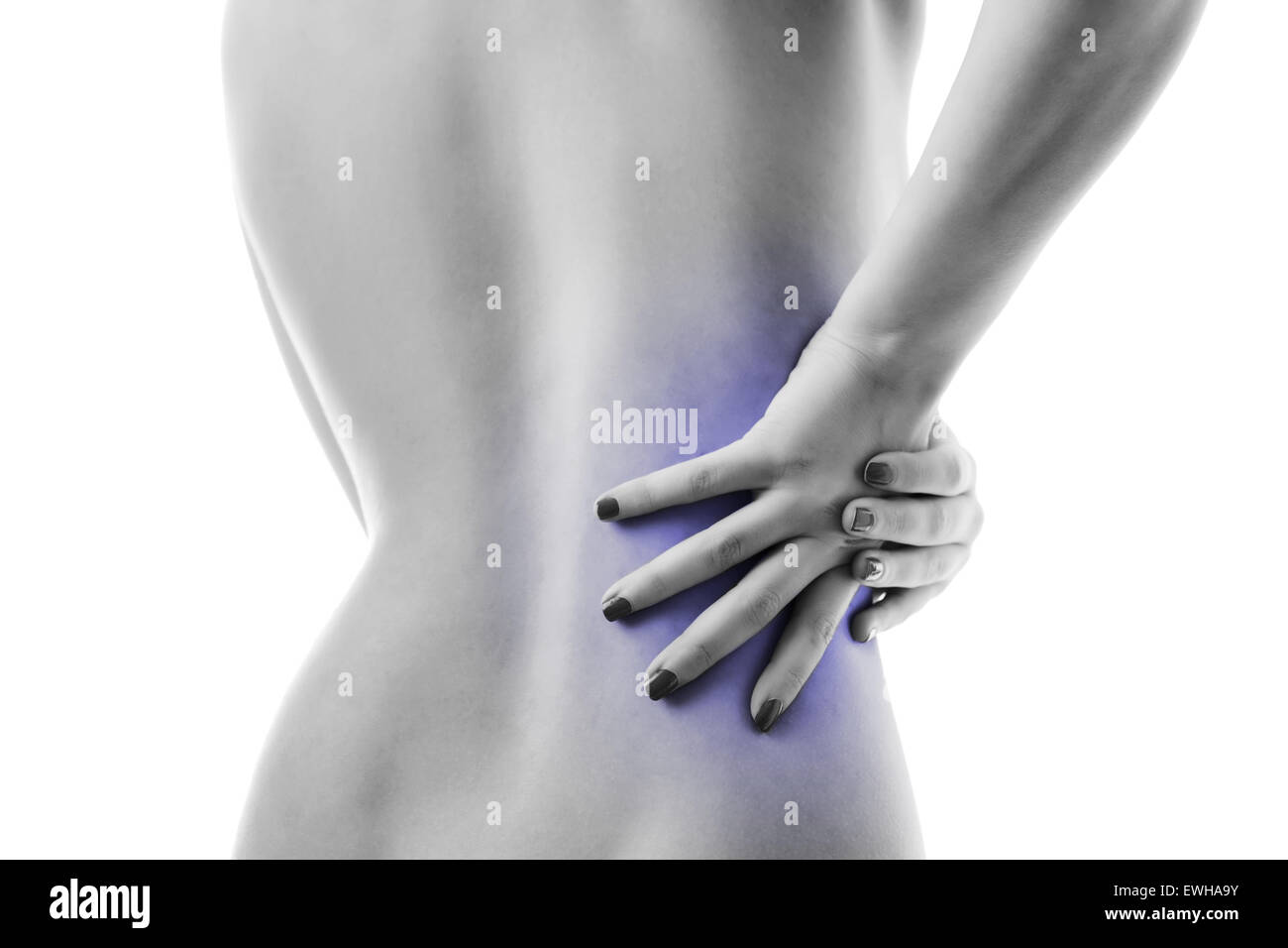 woman with her hand on her back showing signs of back pain Stock Photo ...